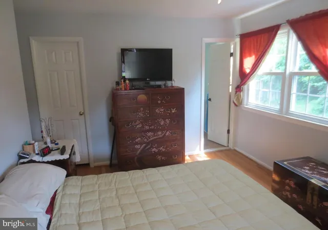 a bedroom with a bed and flat screen tv