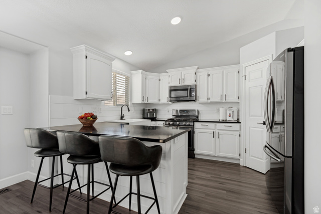 4752 South 4075th Street West Roy, UT 84067 - Photo 6 of 28 Modern kitchen featuring white cabinetry, dark countertops, and wood-finish flooring