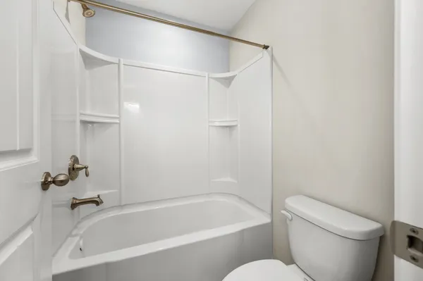 a white bath tub sitting next to a white toilet and sink