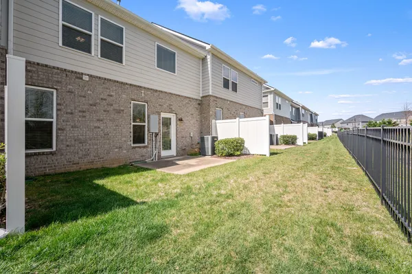 a view of a house with backyard and sitting area