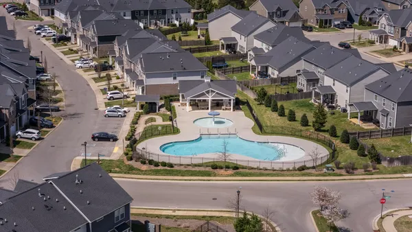 an aerial view of residential houses with outdoor space