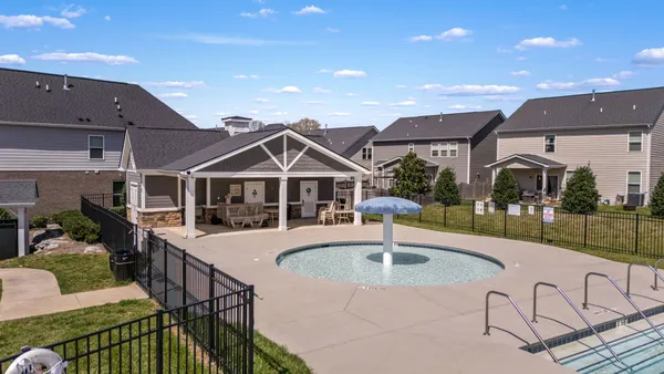 a front view of a house with swimming pool and porch