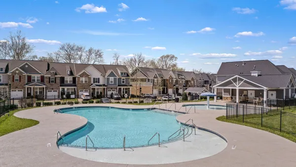 a view of a house with swimming pool and porch