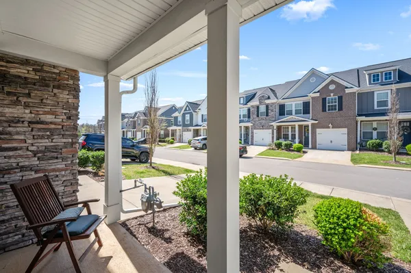 a view of a patio with table and chairs potted plants