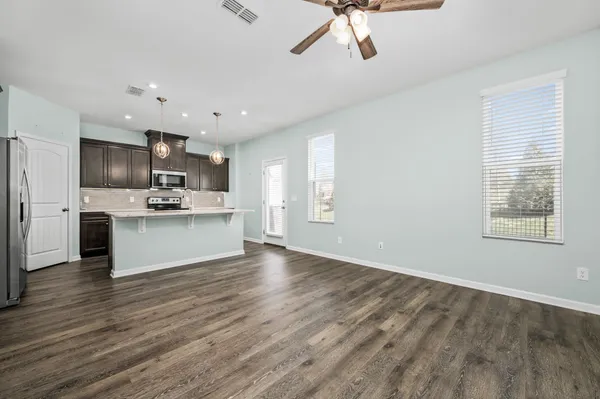 a view of kitchen with cabinets microwave and stove