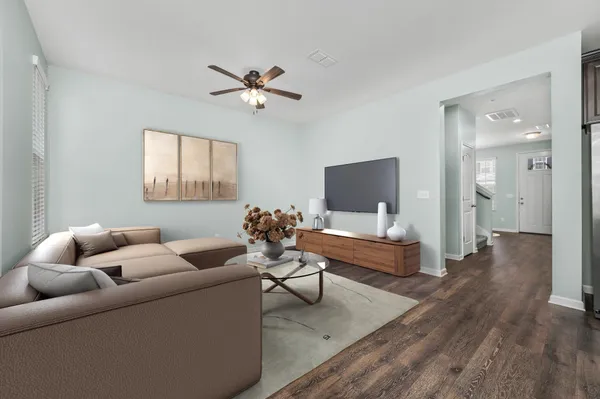 a living room with furniture and a wooden floor