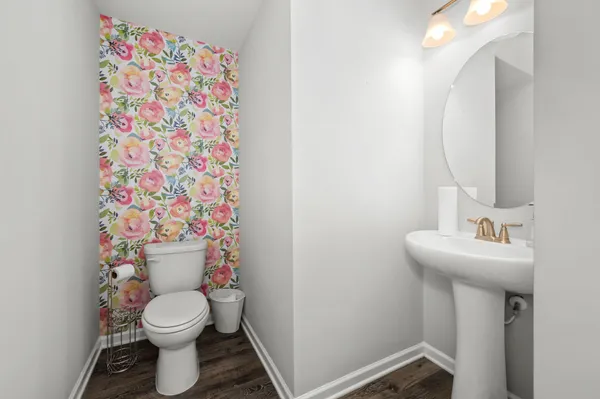 a white toilet sitting next to a white sink