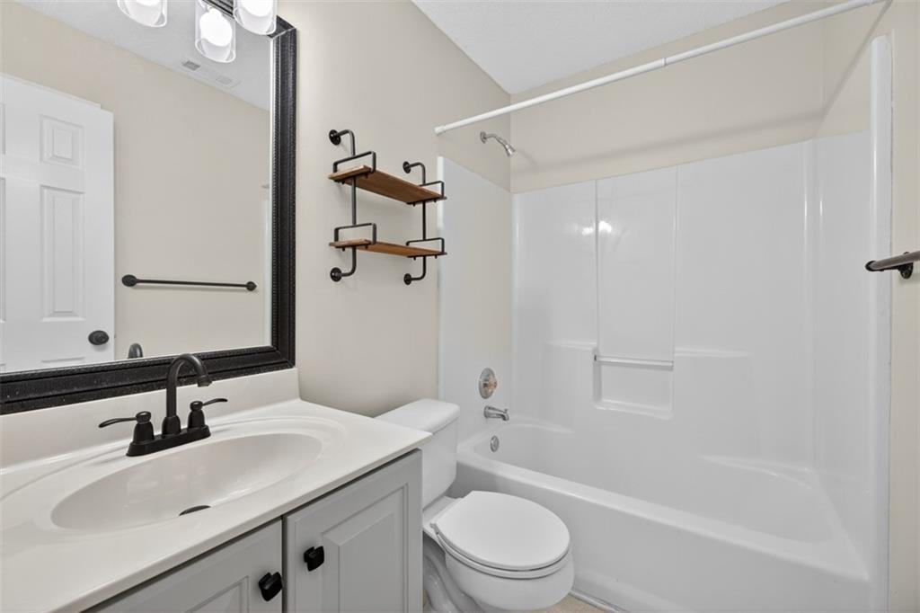 5683 Riverside Walk Drive Northeast Sugar Hill, GA 30518 - Photo 23 of 42 a bathroom with a sink toilet tub and shower