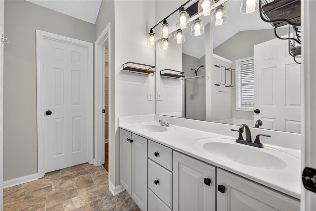 5683 Riverside Walk Drive Northeast Sugar Hill, GA 30518 - Photo 31 of 42 a bathroom with a sink double vanity and a mirror