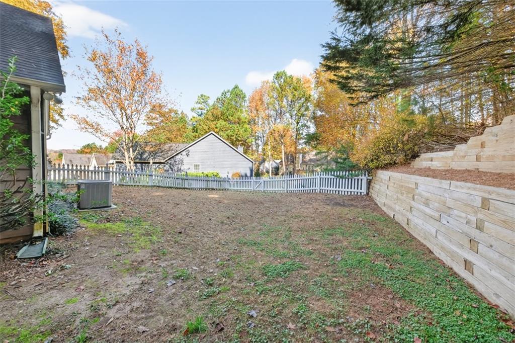 5683 Riverside Walk Drive Northeast Sugar Hill, GA 30518 - Photo 38 of 42 a view of backyard and tree