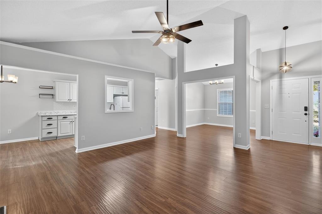 5683 Riverside Walk Drive Northeast Sugar Hill, GA 30518 - Photo 7 of 42 a view of an empty room with a window and wooden floor