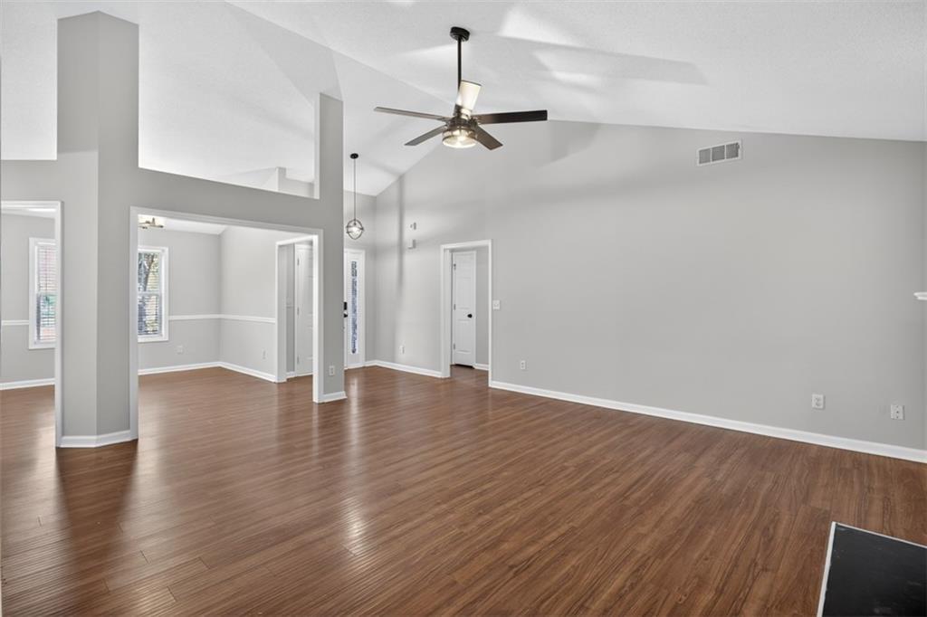 5683 Riverside Walk Drive Northeast Sugar Hill, GA 30518 - Photo 8 of 42 a view of an empty room with wooden floor