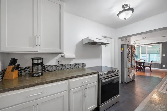 a backyard of a house with table and chairs