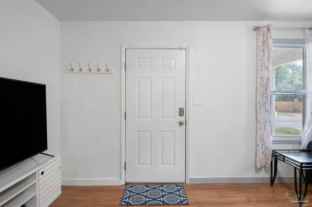 wooden floor in an empty room with a window