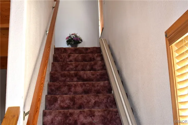a vase of flowers sitting on a table with a mirror