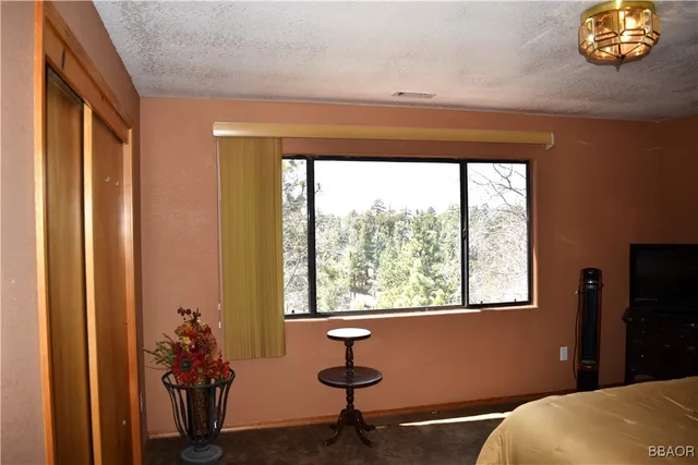 a bedroom with bed and window