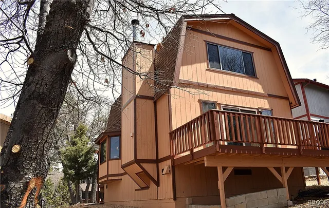 a view of a house with backyard and deck