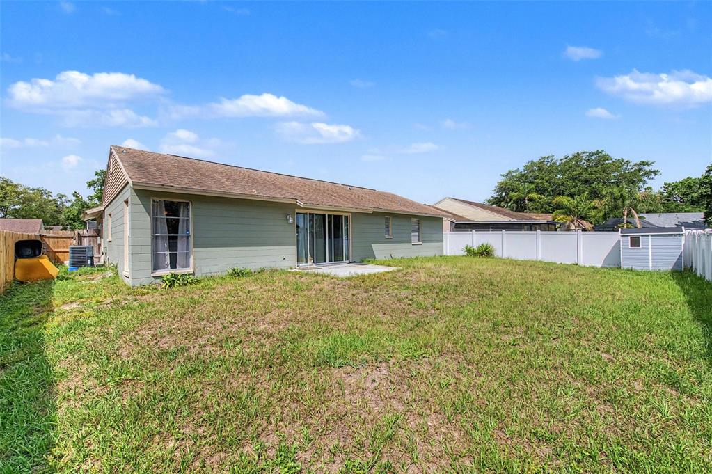 1632 Pintail Court Lutz, FL 33549 - Photo 26 of 34 a view of a house with a backyard