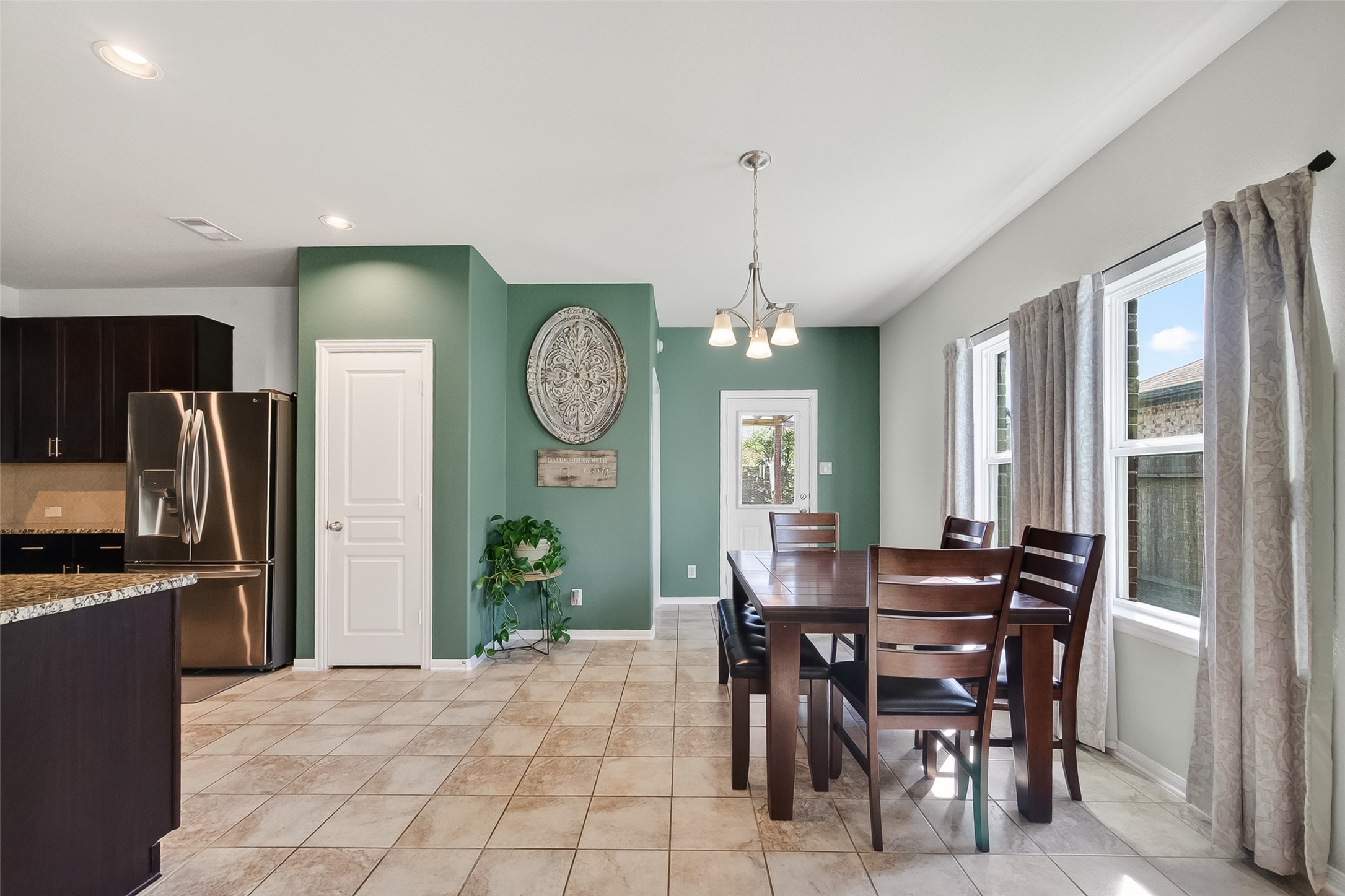 8630 Willet Street Baytown, TX 77521 - Photo 13 of 48 a view of a dining room with furniture and a large window