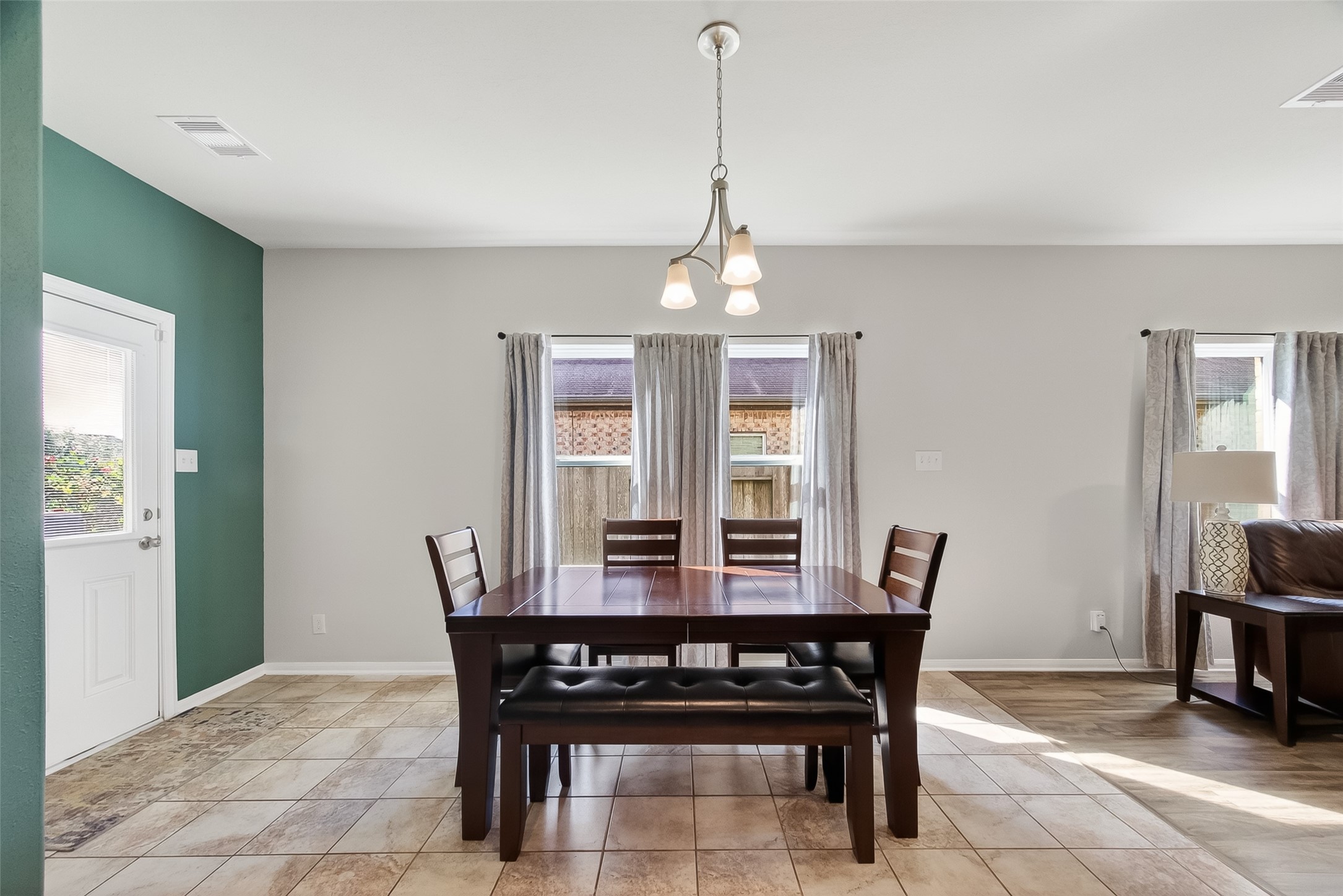 8630 Willet Street Baytown, TX 77521 - Photo 16 of 48 a view of a dining room with furniture window and wooden floor