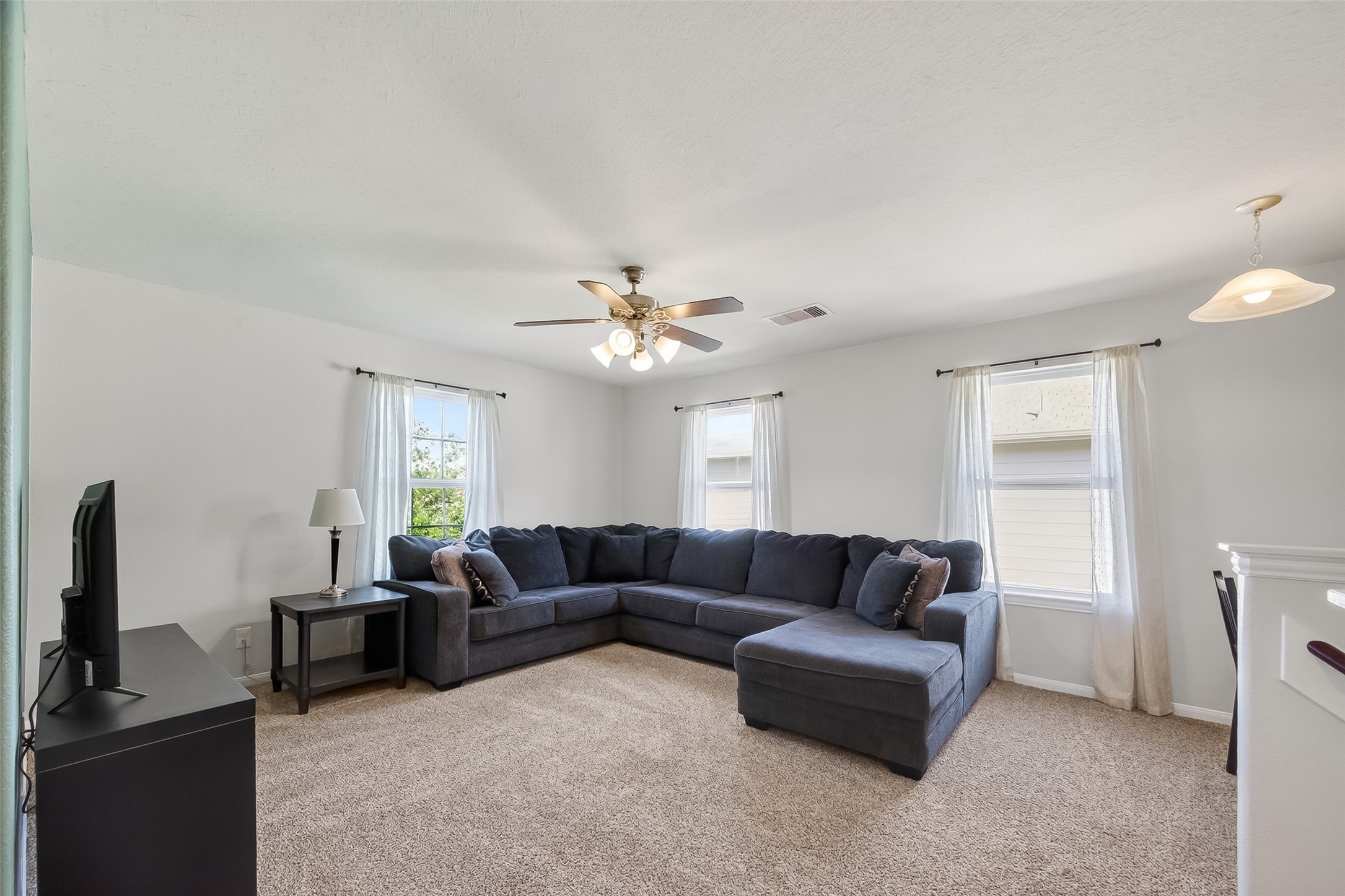 8630 Willet Street Baytown, TX 77521 - Photo 20 of 48 a living room with furniture and a flat screen tv