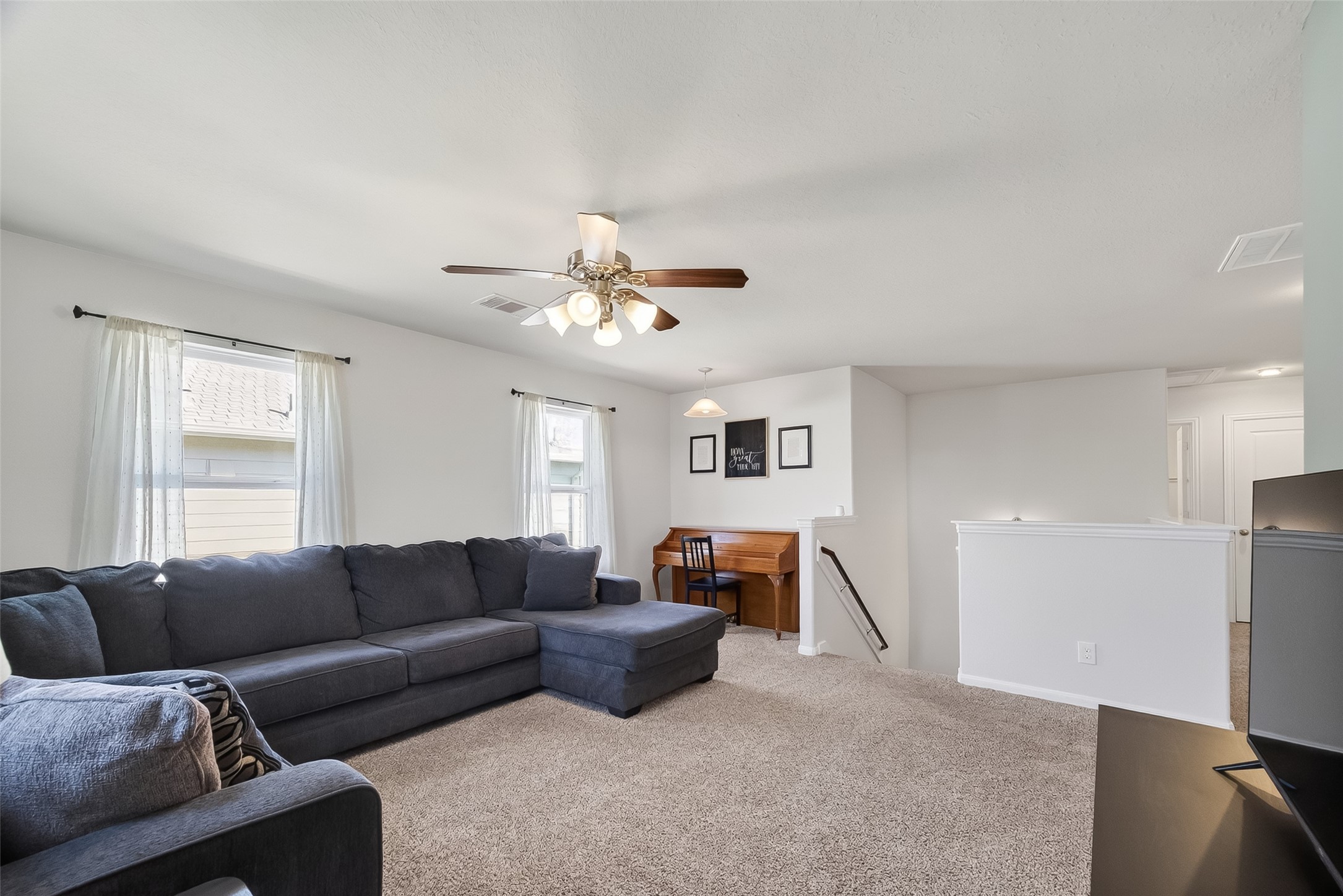 8630 Willet Street Baytown, TX 77521 - Photo 21 of 48 a living room with furniture and a chandelier