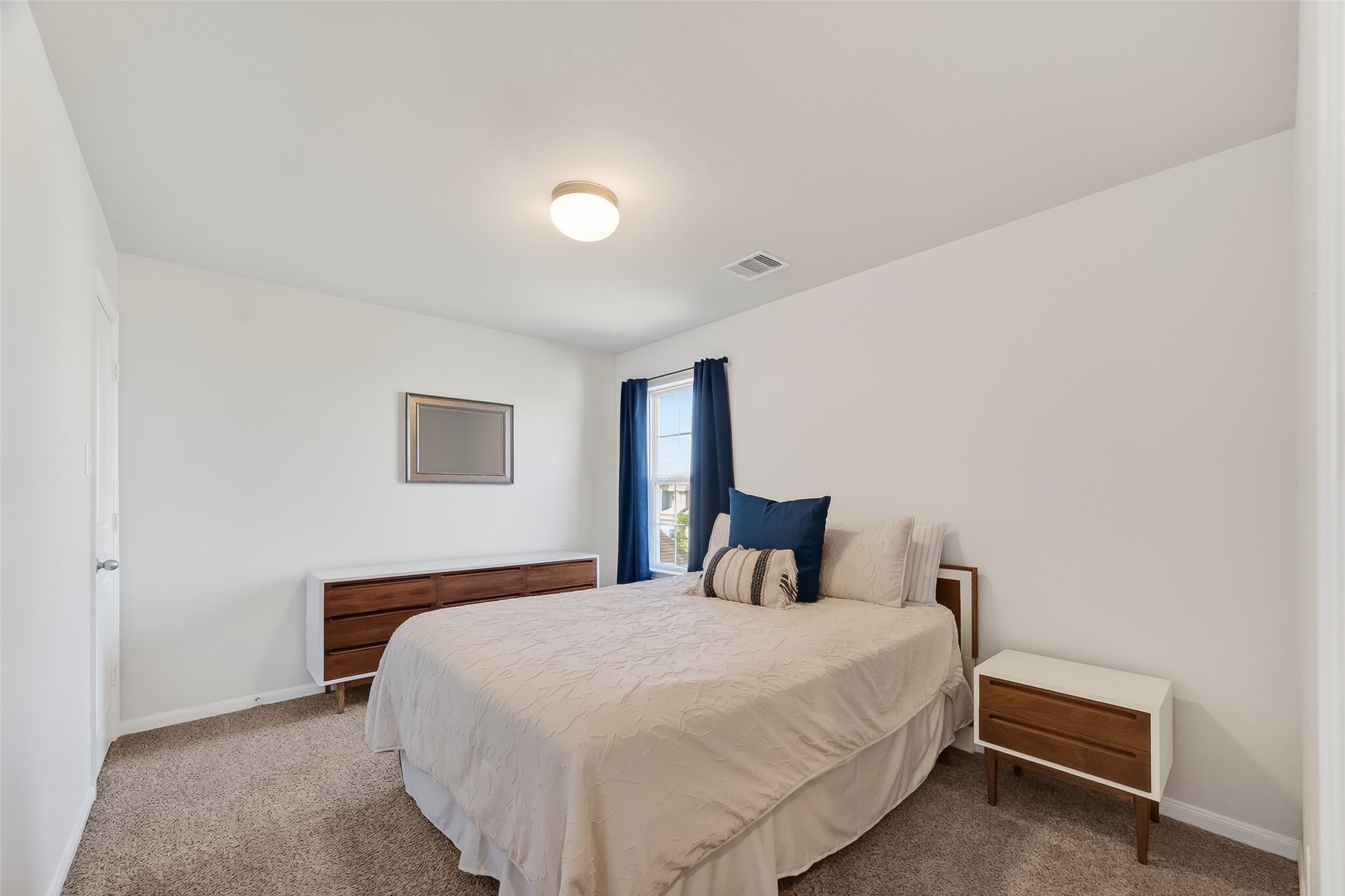 8630 Willet Street Baytown, TX 77521 - Photo 23 of 48 a bedroom with a bed and a night stand