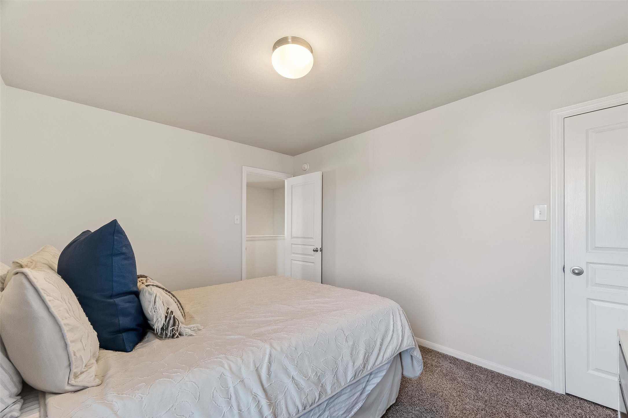 8630 Willet Street Baytown, TX 77521 - Photo 25 of 48 a bedroom with a bed and a chair