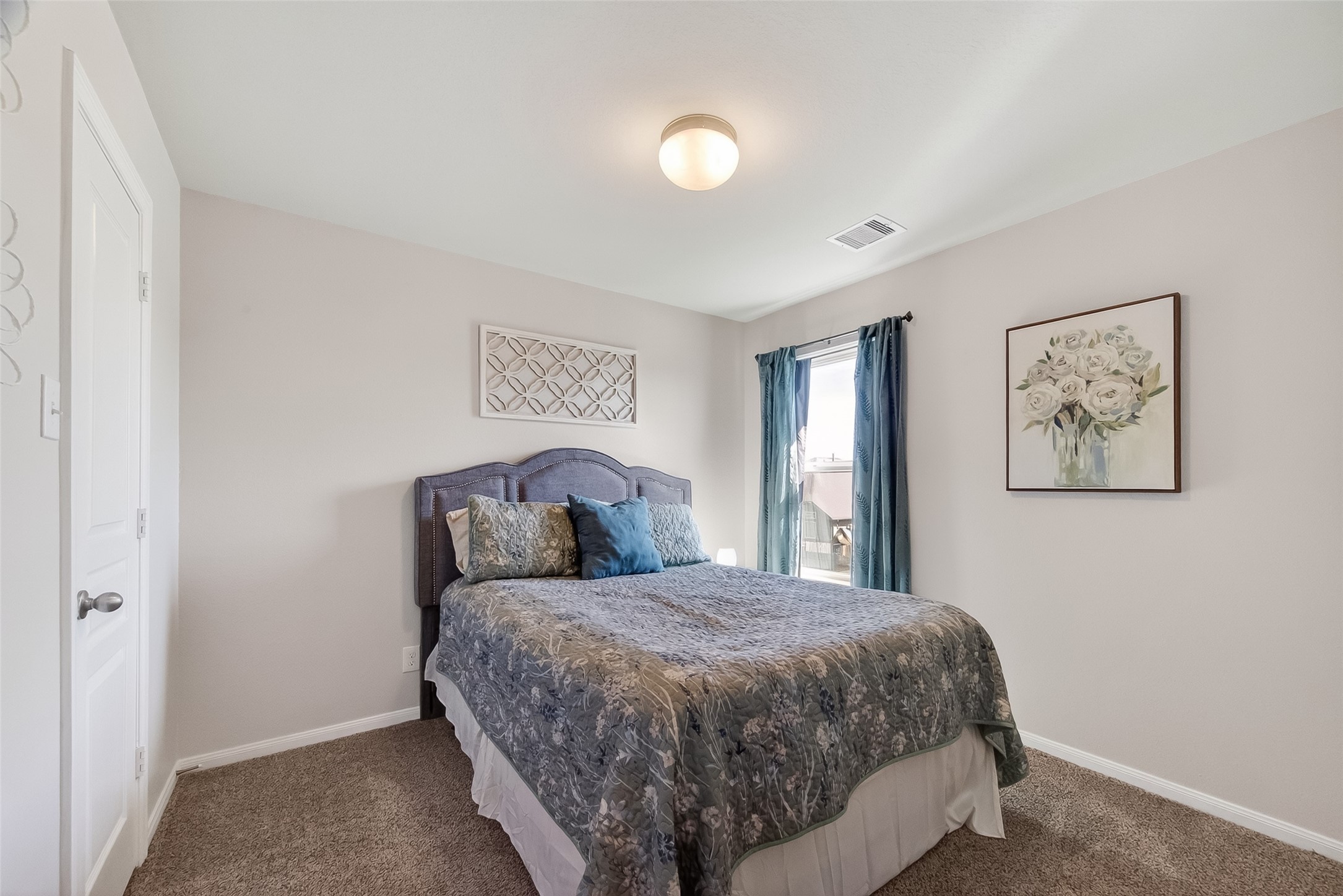 8630 Willet Street Baytown, TX 77521 - Photo 31 of 48 a bed sitting in a bedroom next to a window