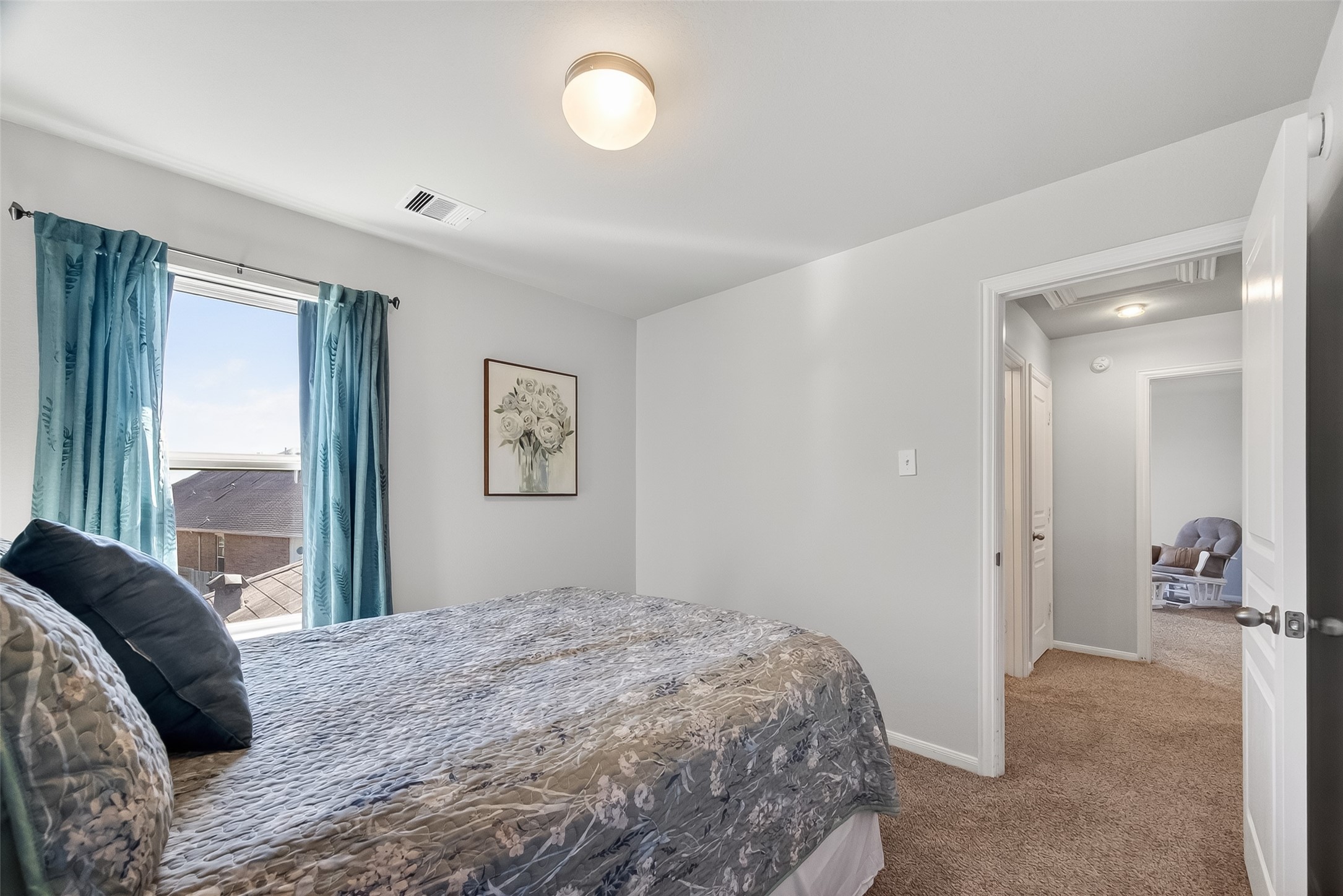 8630 Willet Street Baytown, TX 77521 - Photo 32 of 48 a bedroom with a large bed and a large window