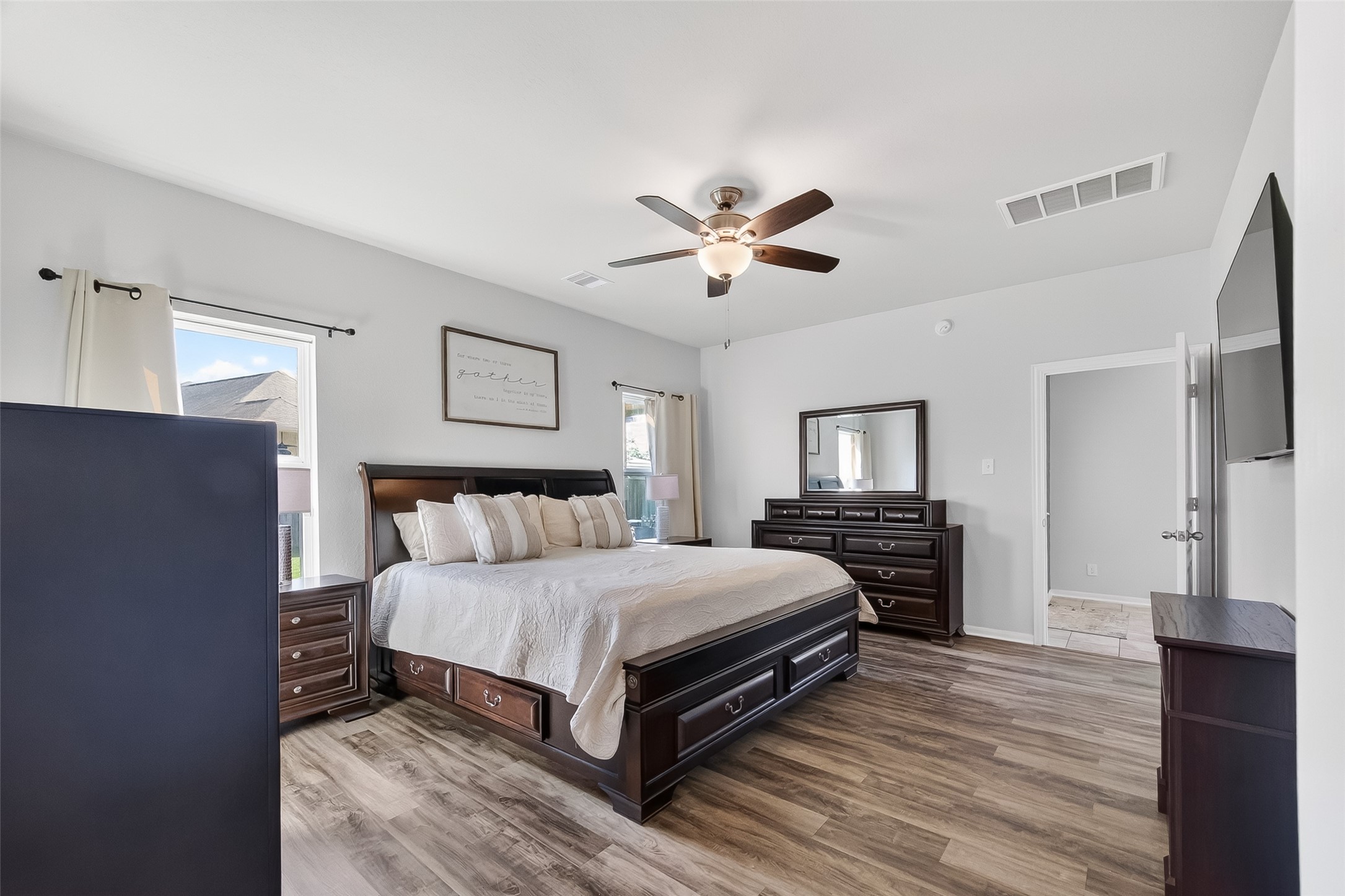 8630 Willet Street Baytown, TX 77521 - Photo 36 of 48 a bedroom with a bed and a chandelier