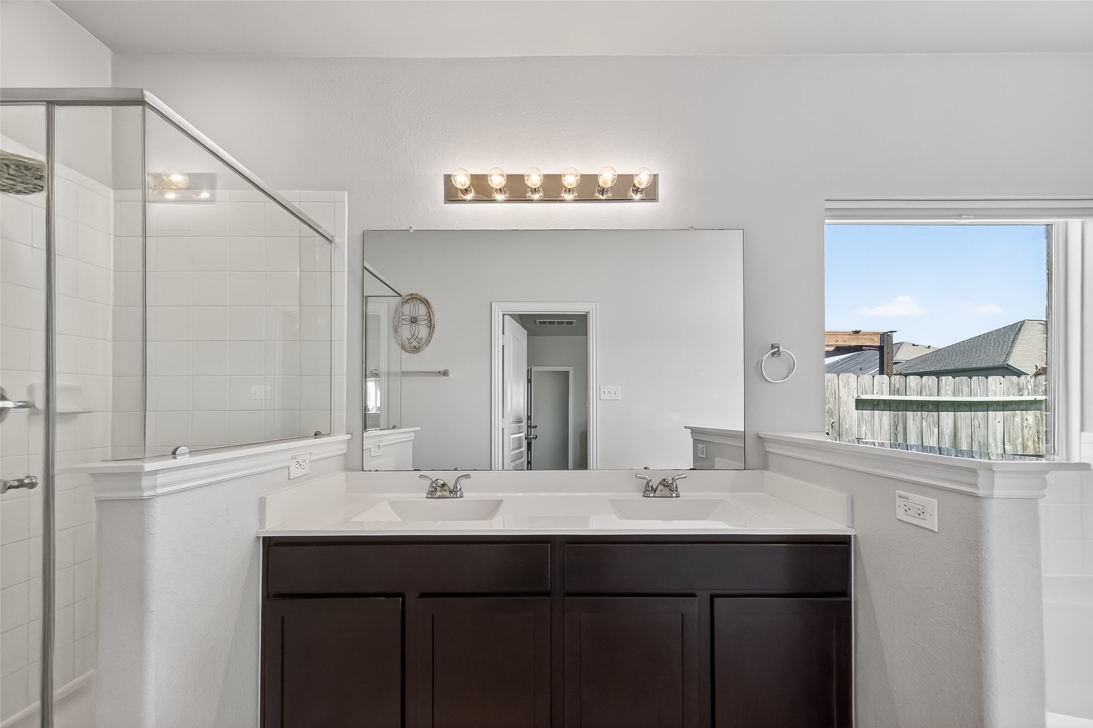 8630 Willet Street Baytown, TX 77521 - Photo 37 of 48 a bathroom with a sink a mirror and a window