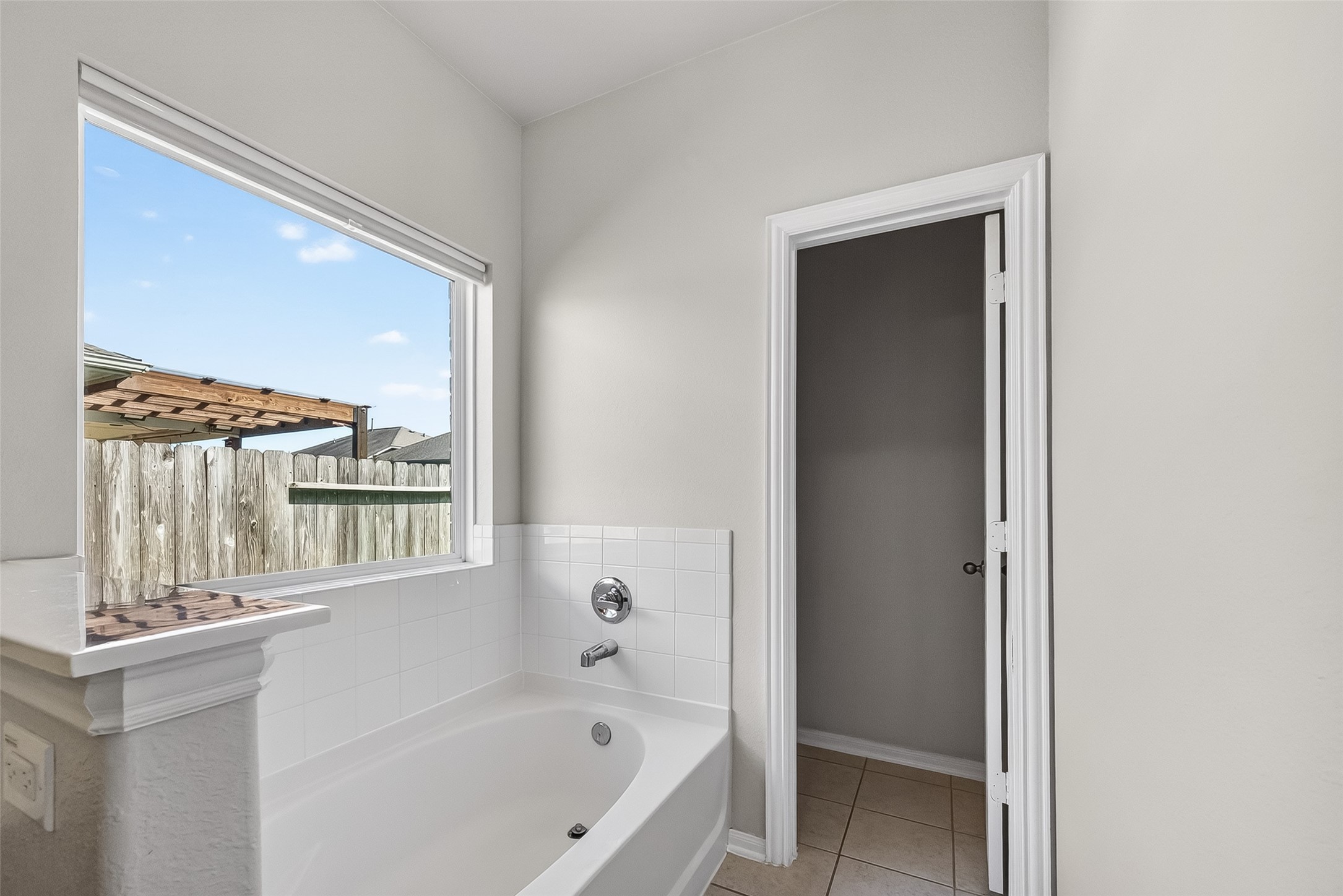 8630 Willet Street Baytown, TX 77521 - Photo 39 of 48 a bathroom with a bathtub and a shower