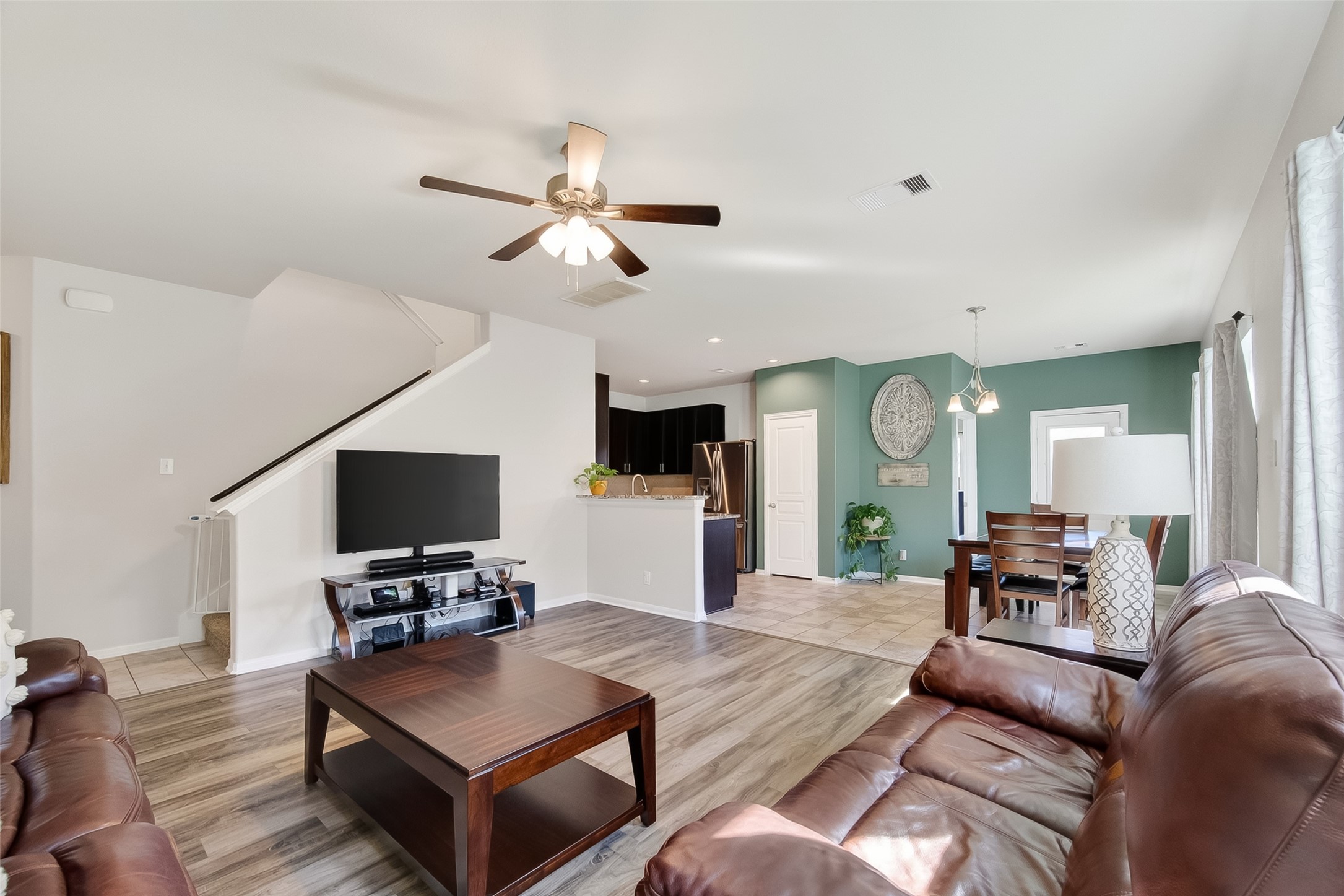 8630 Willet Street Baytown, TX 77521 - Photo 7 of 48 a living room with furniture a fireplace and a flat screen tv