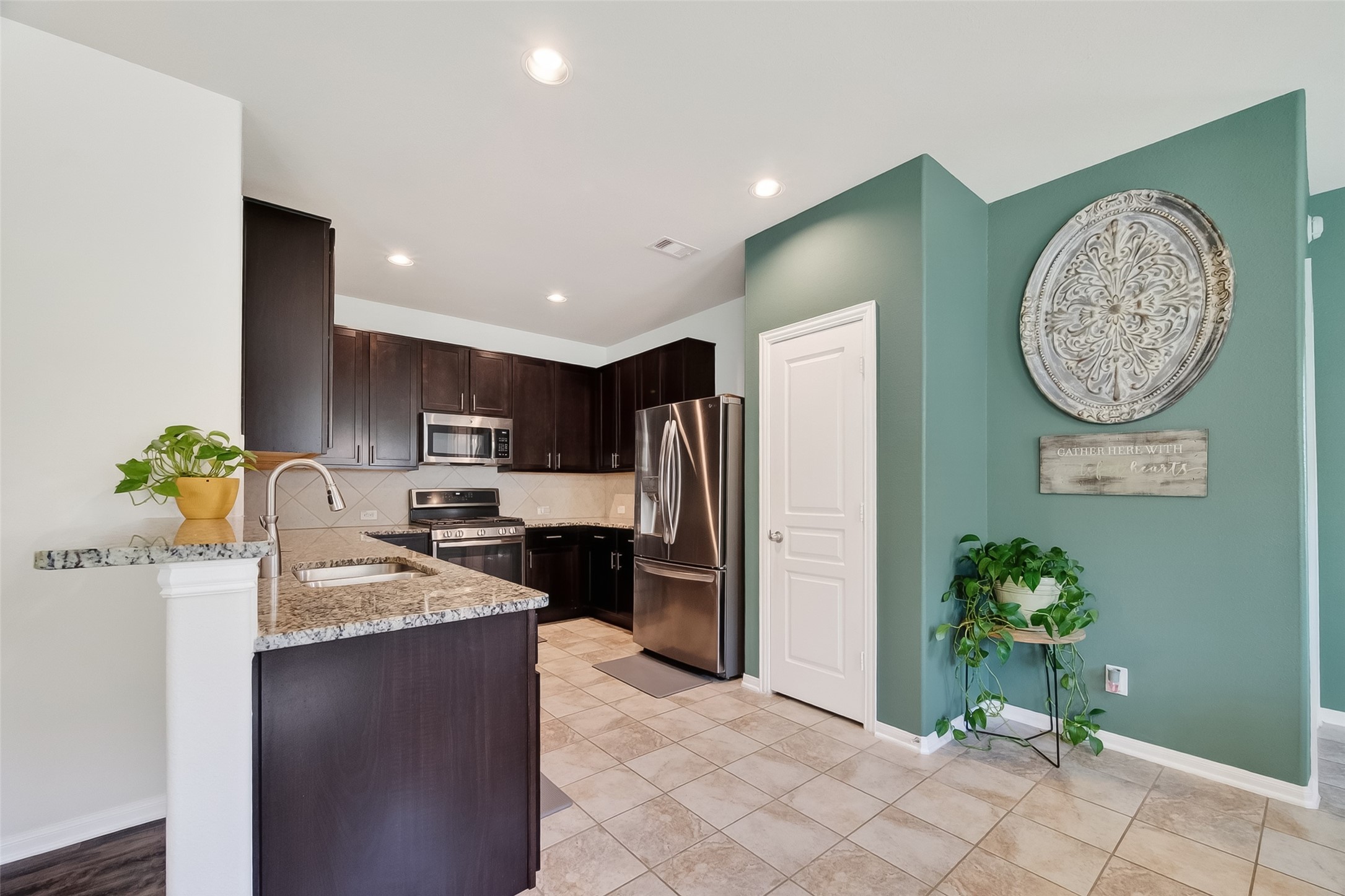 8630 Willet Street Baytown, TX 77521 - Photo 8 of 48 kitchen with granite countertops and tile floors plus pantry