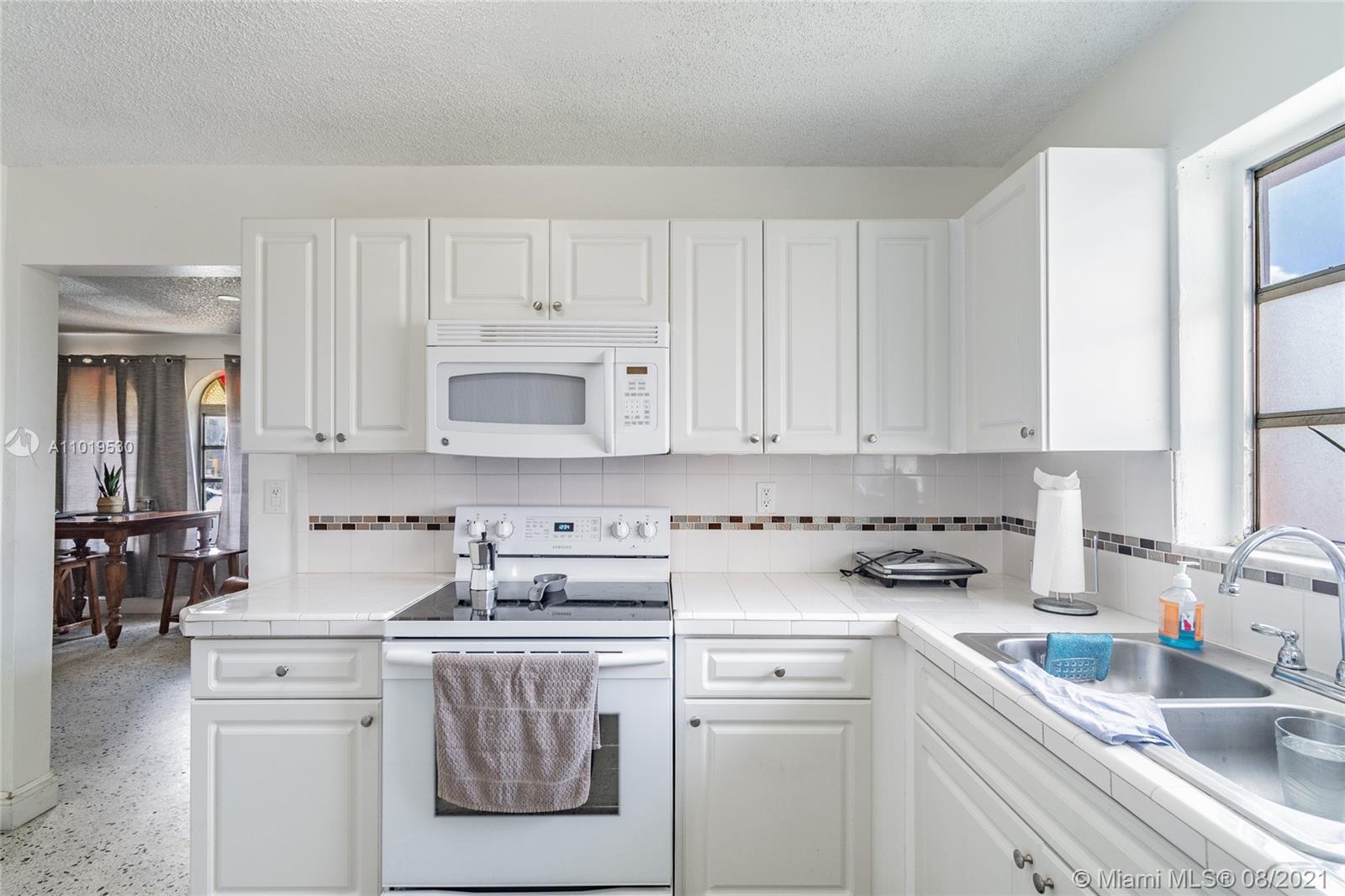 Hialeah Acres Hialeah, FL 33010 - Photo 14 of 45 a kitchen with cabinets appliances a sink and a counter top space