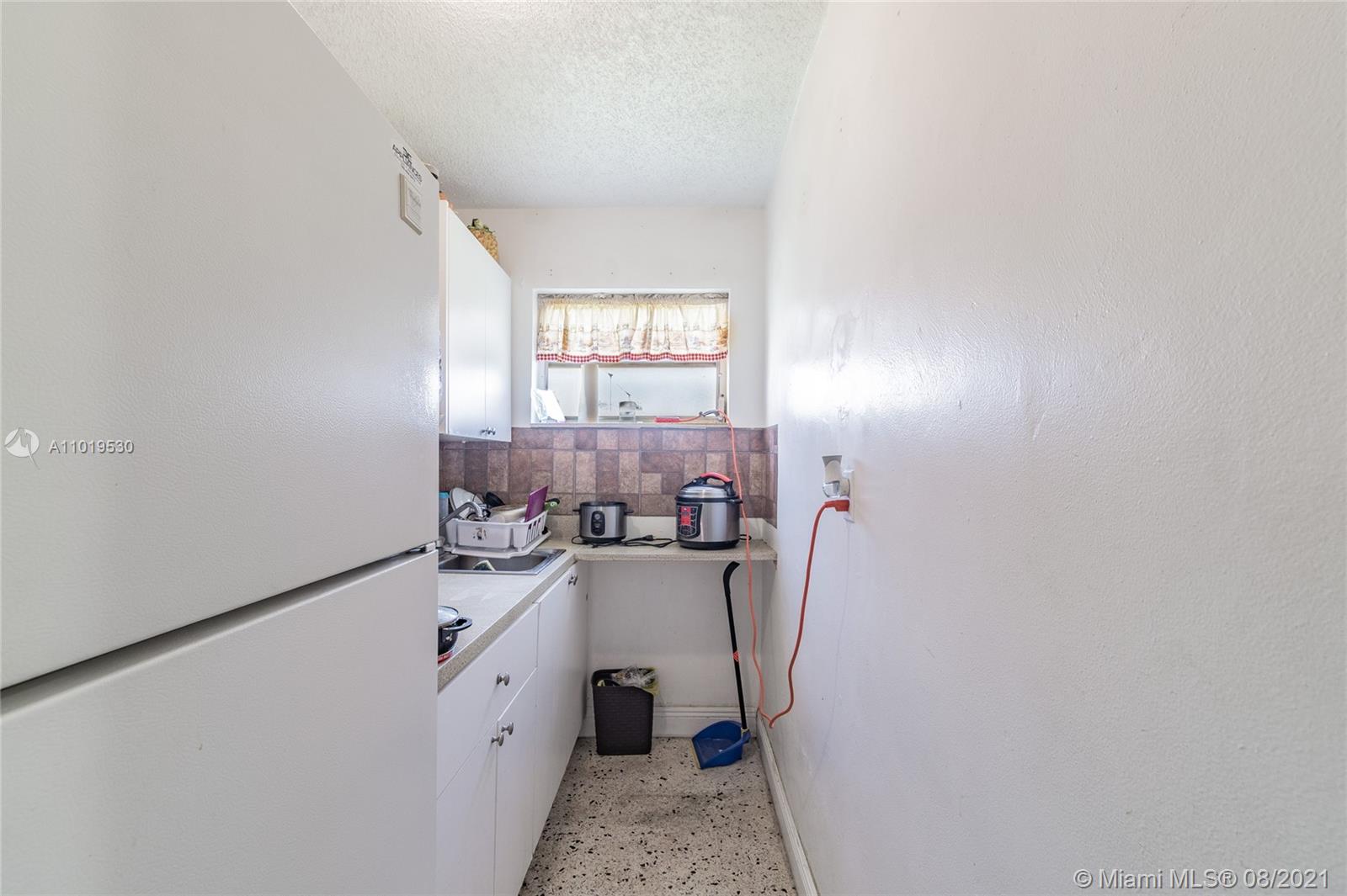 Hialeah Acres Hialeah, FL 33010 - Photo 25 of 45 a utility room with cabinets washer and dryer