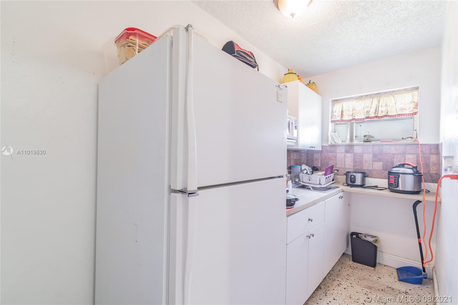 Hialeah Acres Hialeah, FL 33010 - Photo 26 of 45 a utility room with cabinets washer and dryer