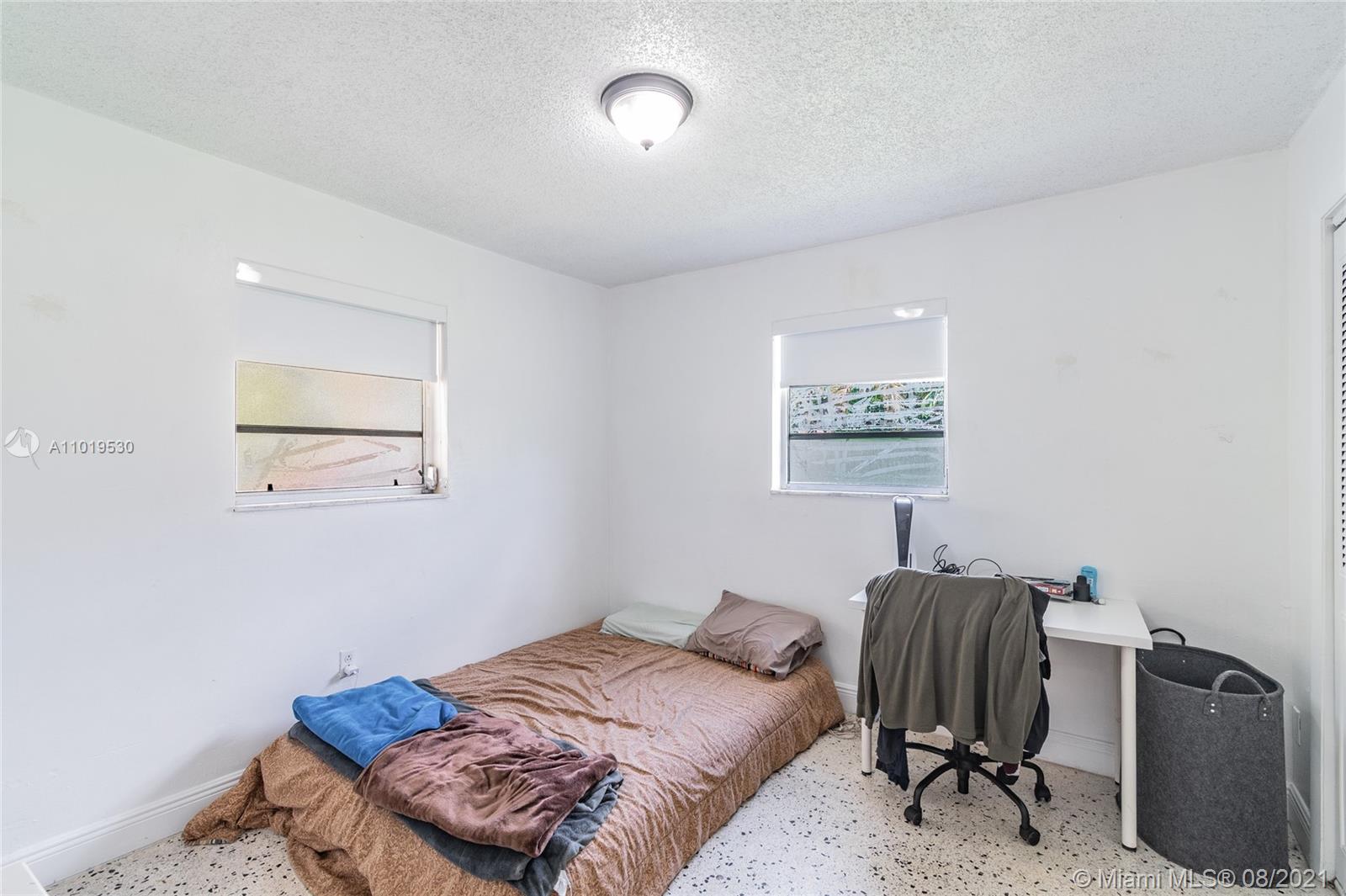 Hialeah Acres Hialeah, FL 33010 - Photo 33 of 45 a bedroom with a bed and a chair in it