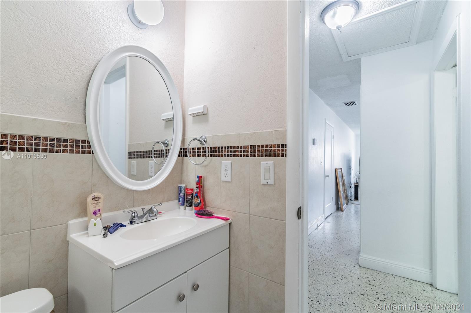 Hialeah Acres Hialeah, FL 33010 - Photo 34 of 45 a bathroom with a sink and a mirror