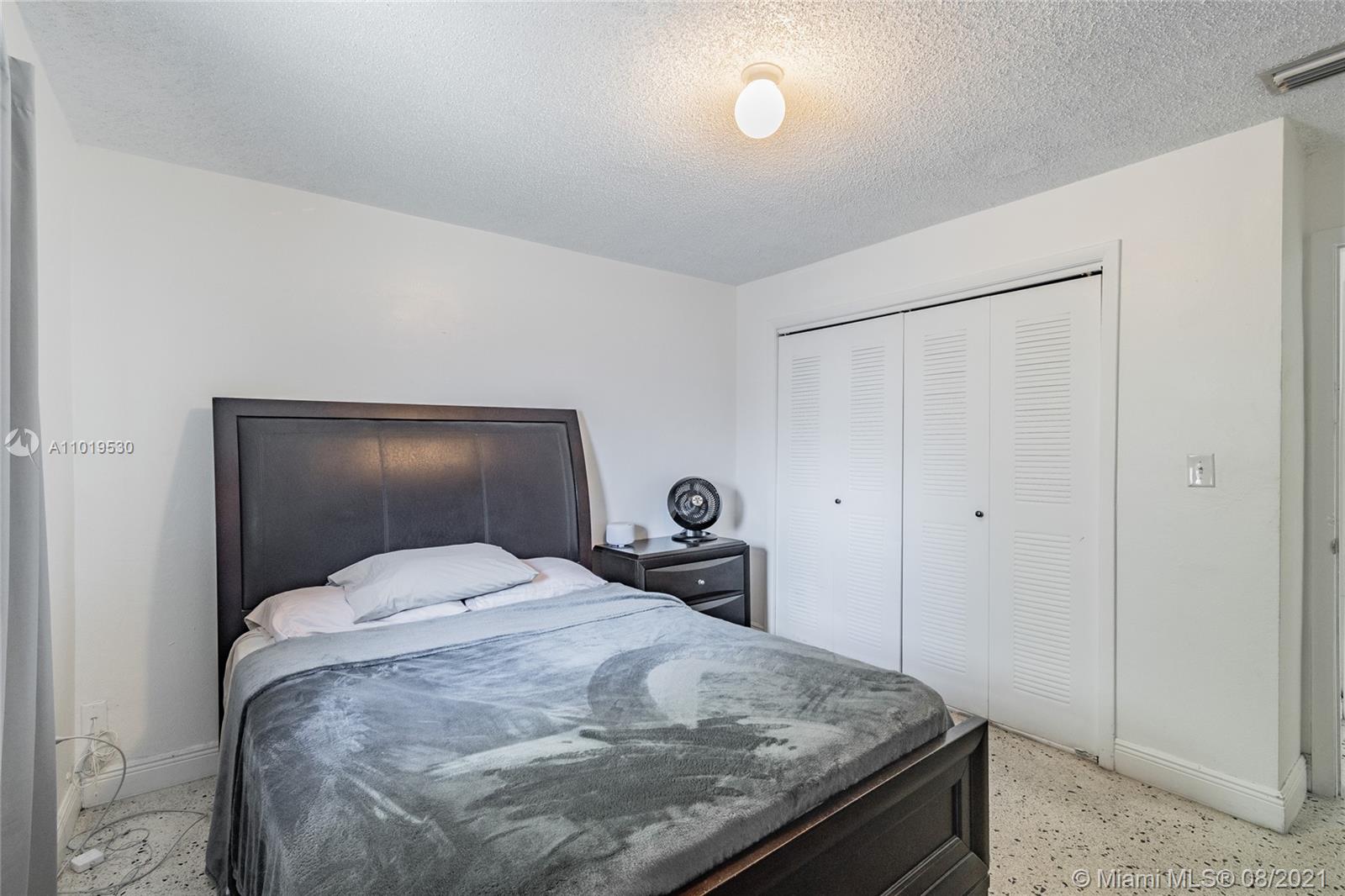 Hialeah Acres Hialeah, FL 33010 - Photo 5 of 45 a bedroom with a bed and lamp