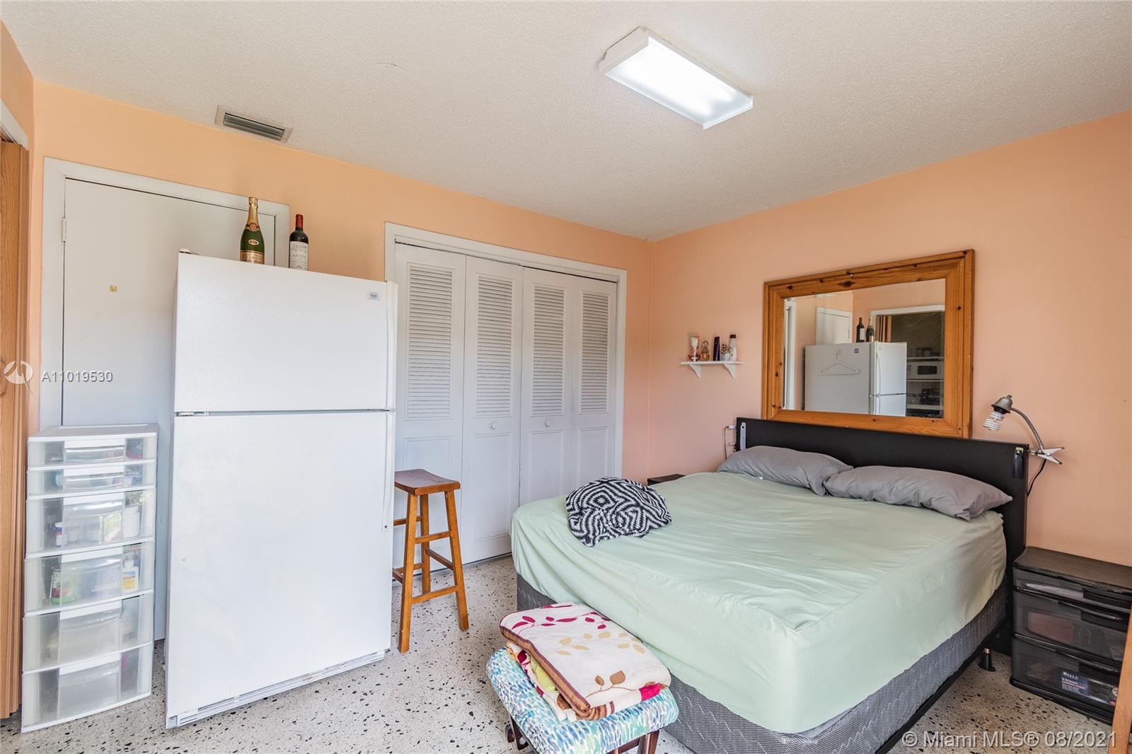 Hialeah Acres Hialeah, FL 33010 - Photo 45 of 45 a bedroom with a bed and a refrigerator