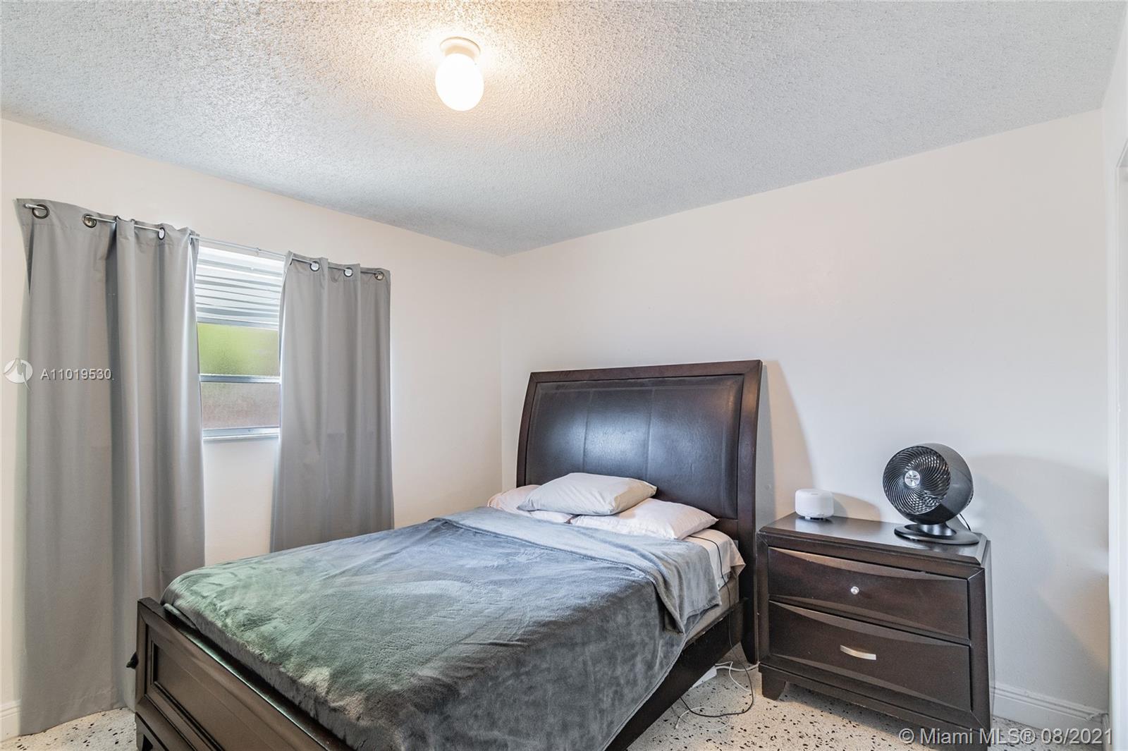 Hialeah Acres Hialeah, FL 33010 - Photo 7 of 45 a bedroom with a bed and cabinets