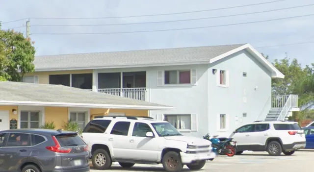 a view of a white car parked in front of a house