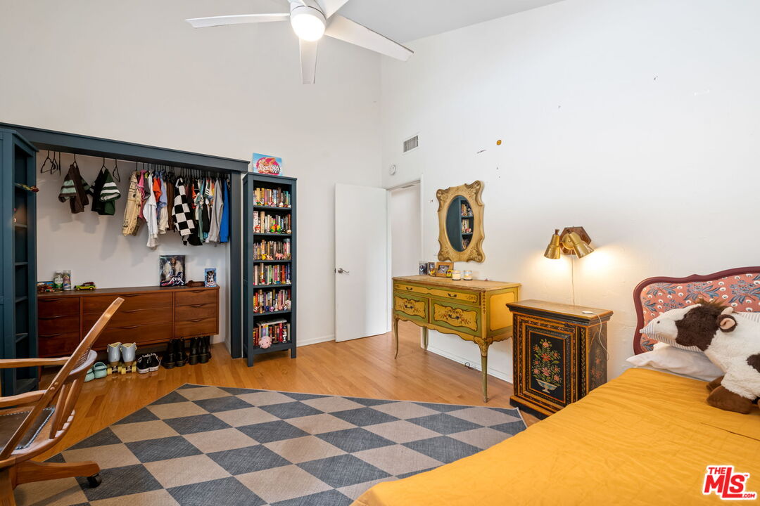 2437 Stokes Canyon Road Calabasas, CA 91302 - Photo 18 of 60 a bedroom with a bed and wooden floor