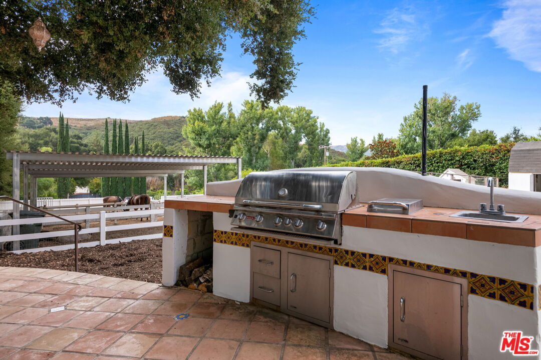 2437 Stokes Canyon Road Calabasas, CA 91302 - Photo 34 of 60 a terrace view with sitting space and garden view