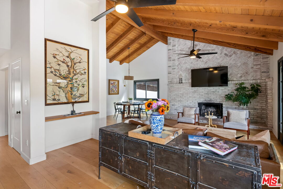 2437 Stokes Canyon Road Calabasas, CA 91302 - Photo 4 of 60 a living room with furniture and a fireplace