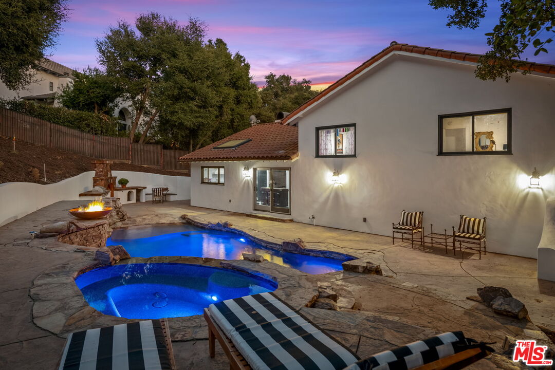 2437 Stokes Canyon Road Calabasas, CA 91302 - Photo 54 of 60 a view of a house with swimming pool and sitting area