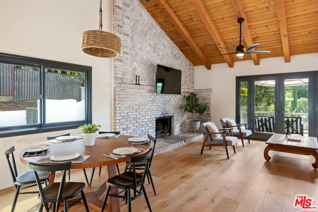 2437 Stokes Canyon Road Calabasas, CA 91302 - Photo 7 of 60 a dining room with furniture garden view and a chandelier