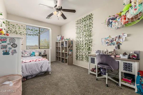 a bedroom with bed and a chandelier